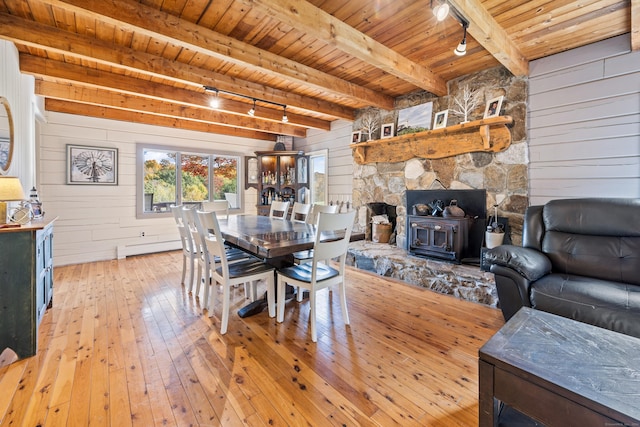 dining room with beam ceiling, light hardwood / wood-style flooring, wooden ceiling, and track lighting