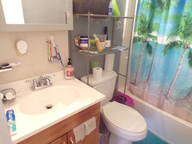 full bathroom with vanity, toilet, decorative backsplash, and shower / bath combo