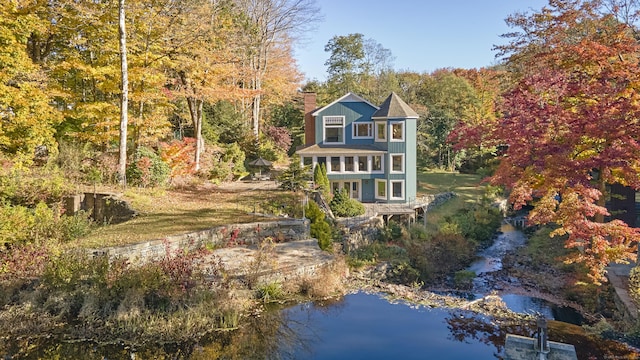 rear view of house with a water view