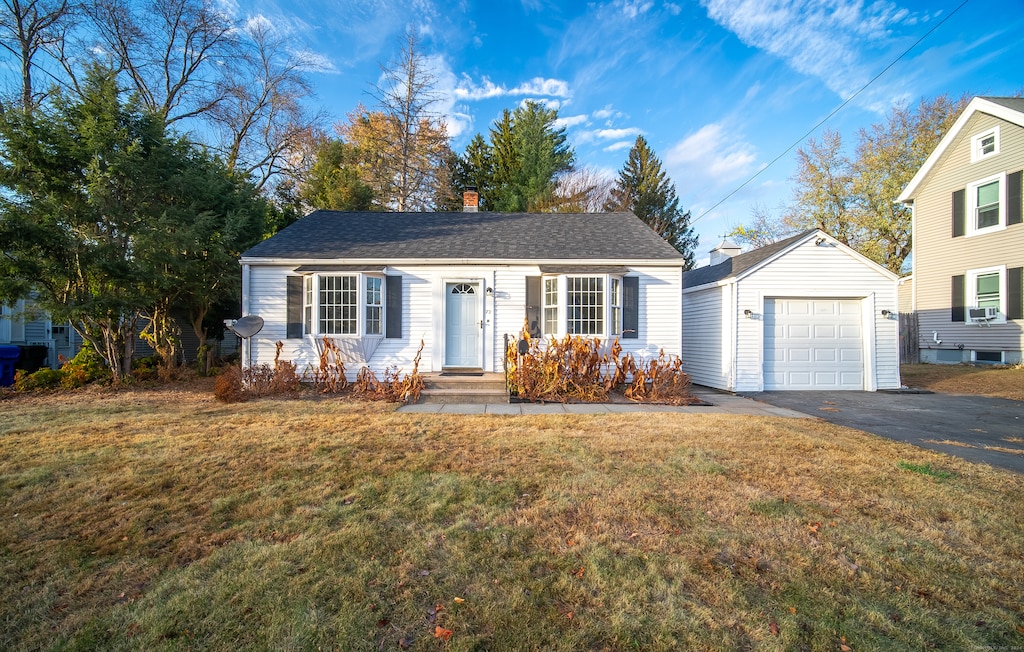 view of front of home featuring a garage and a front lawn