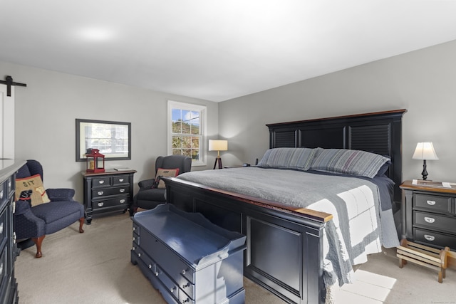 carpeted bedroom with a barn door