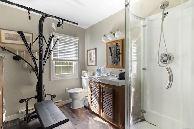 bathroom featuring a baseboard radiator, walk in shower, wood-type flooring, toilet, and vanity