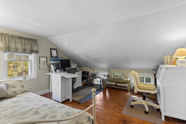 bedroom with dark hardwood / wood-style flooring and lofted ceiling