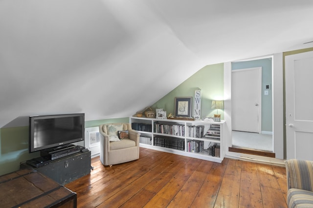 sitting room with hardwood / wood-style flooring and lofted ceiling