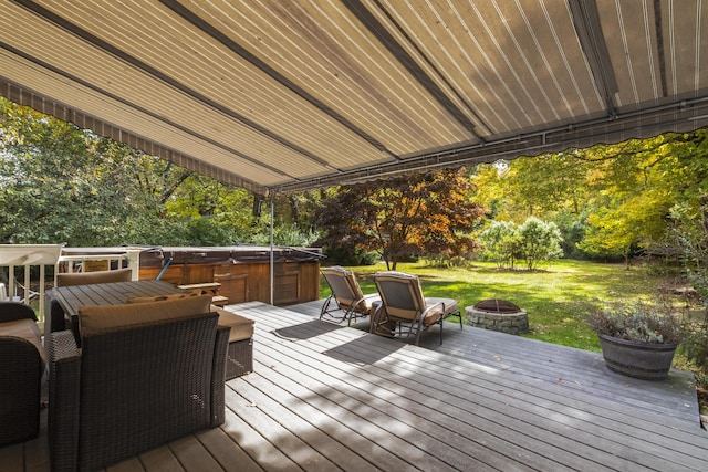 wooden deck with a fire pit and a hot tub