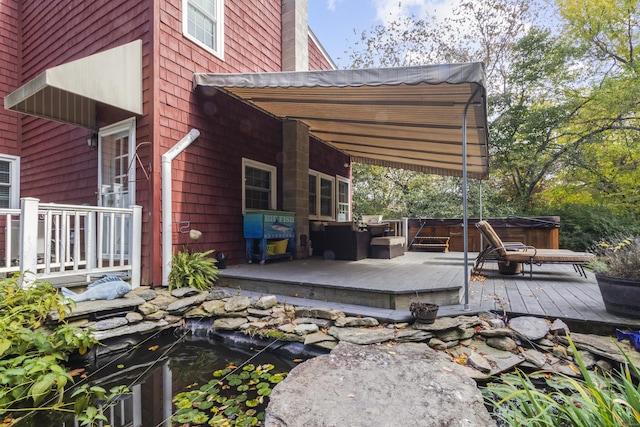 wooden terrace with a hot tub