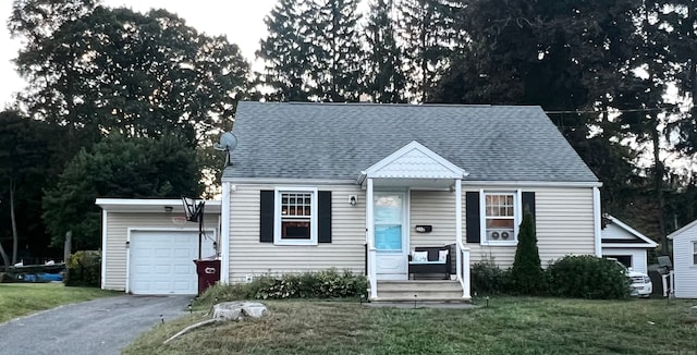 view of front of property featuring a front yard and a garage