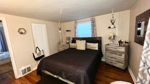 bedroom with dark wood-type flooring