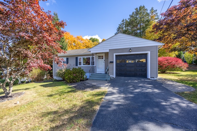 view of front facade with a front yard and a garage