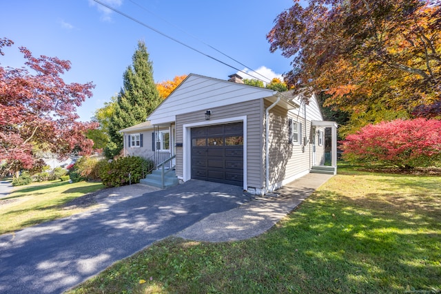 view of front of property with a front yard and a garage