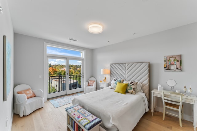 bedroom with access to outside and light wood-type flooring