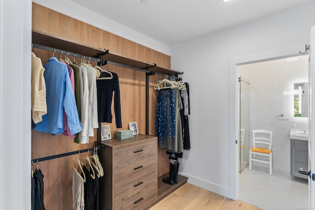 spacious closet featuring light wood-type flooring