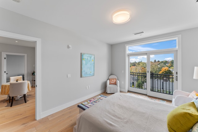 bedroom with light wood-type flooring and access to outside