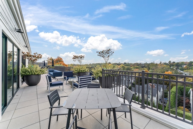 view of patio with an outdoor living space and a balcony