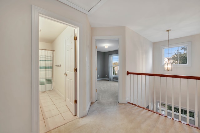 hallway featuring light colored carpet