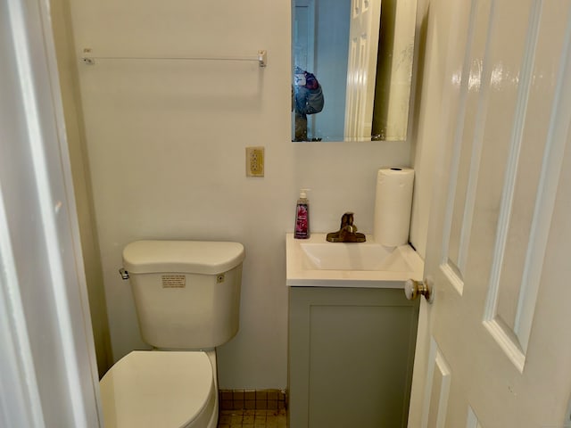 bathroom featuring vanity, toilet, and tile patterned floors