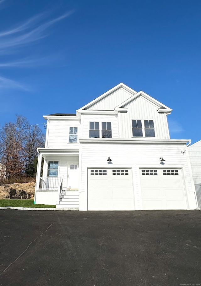 view of front facade with a porch and a garage