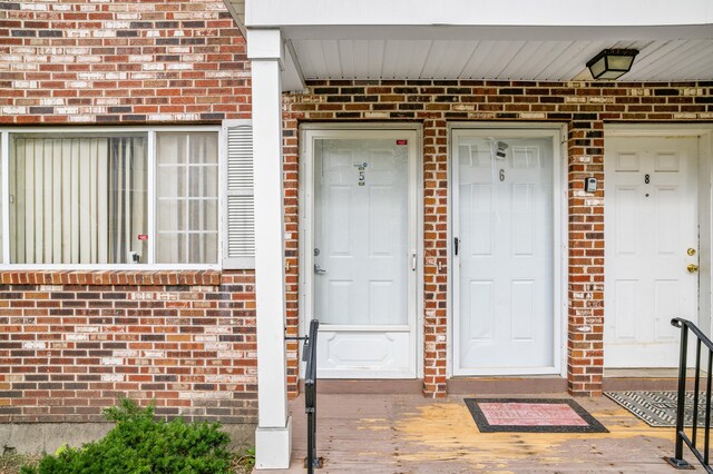 entrance to property with brick siding