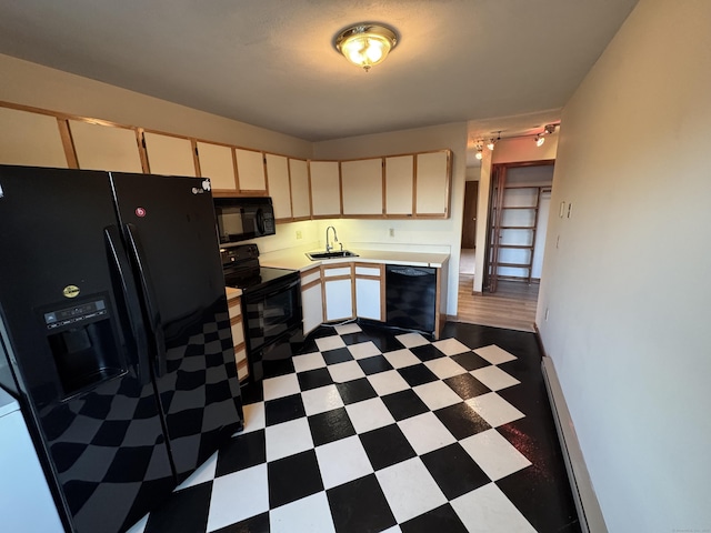 kitchen featuring black appliances, dark floors, a sink, and light countertops