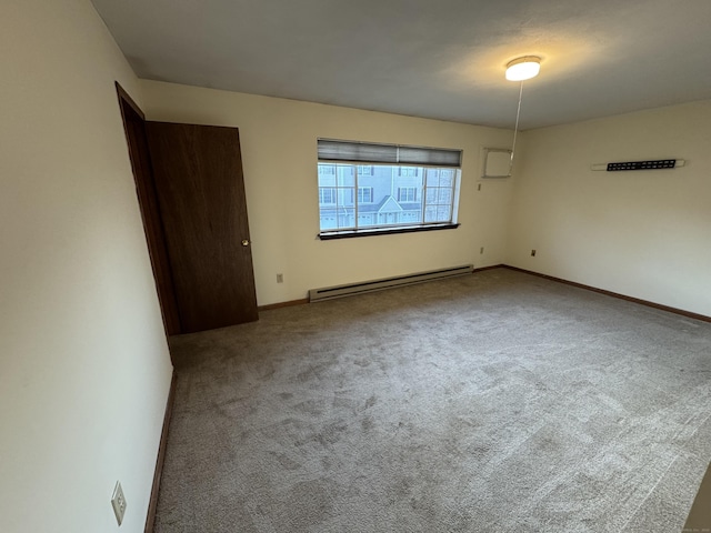 spare room featuring a baseboard radiator, baseboards, and carpet flooring