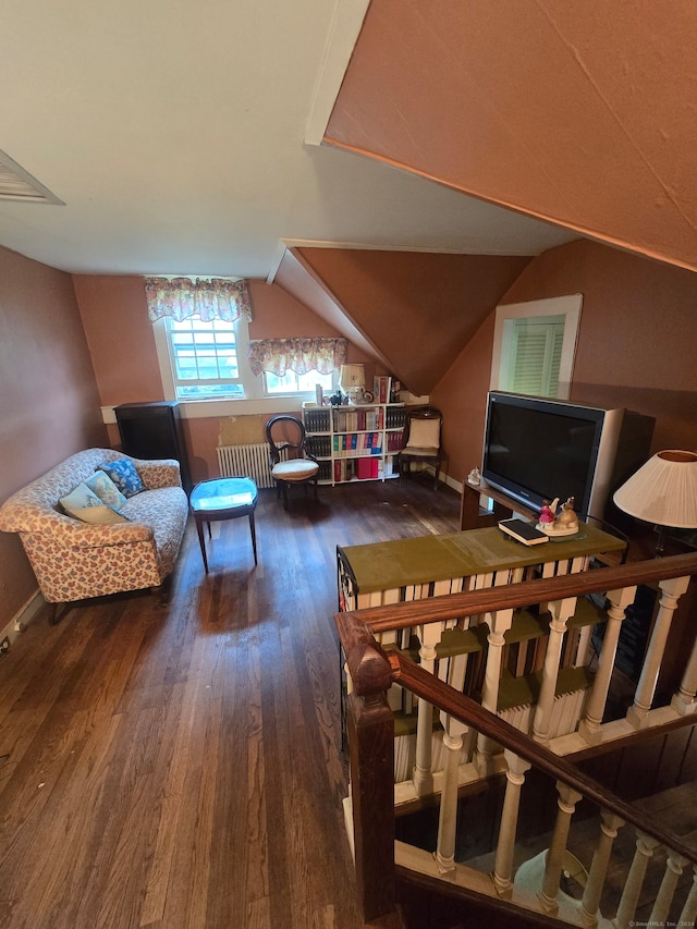 bonus room featuring vaulted ceiling, hardwood / wood-style flooring, and radiator heating unit