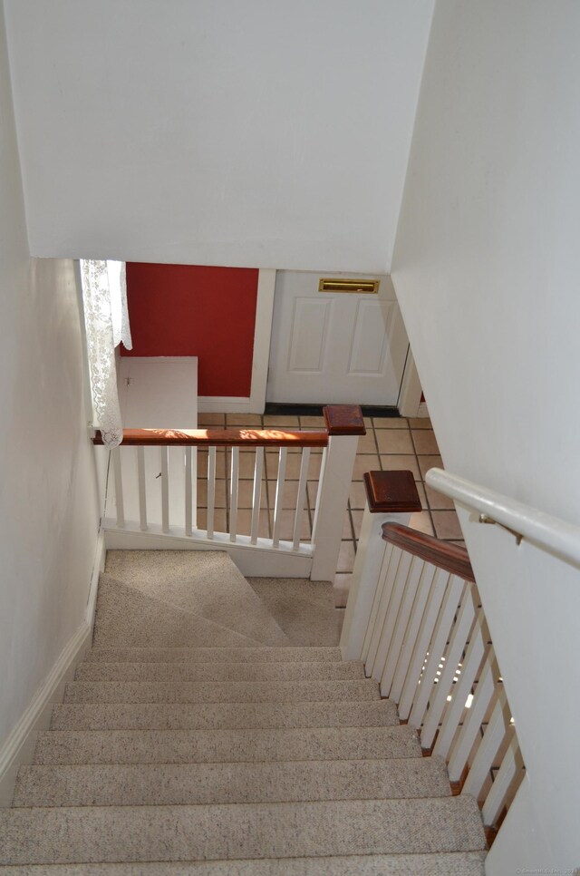 stairway with tile patterned floors