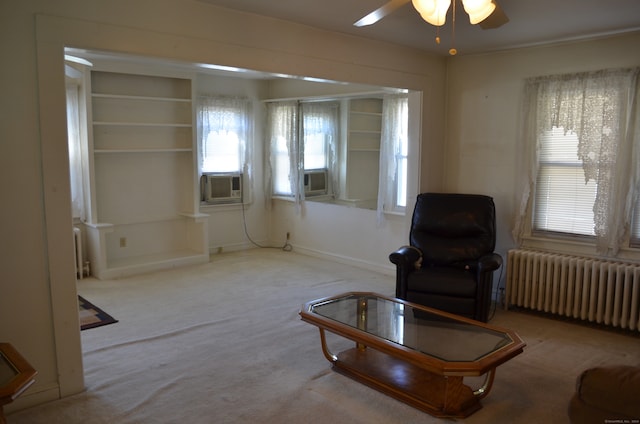 living area featuring cooling unit, ceiling fan, carpet flooring, and radiator