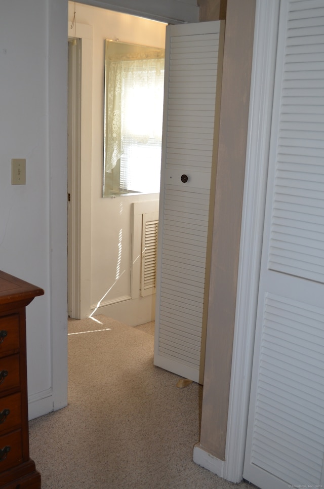 hallway with light colored carpet