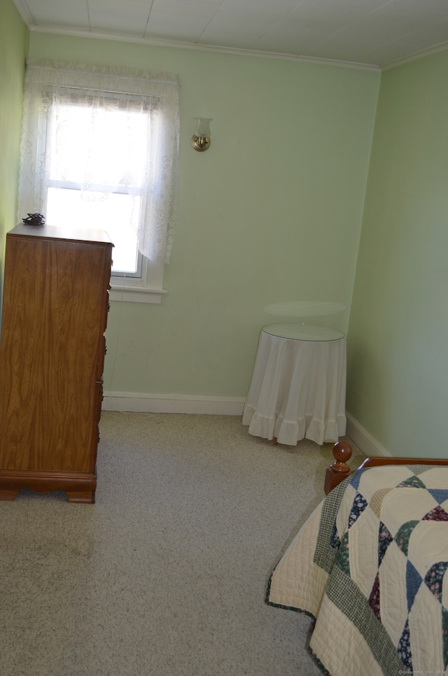 carpeted bedroom featuring ornamental molding