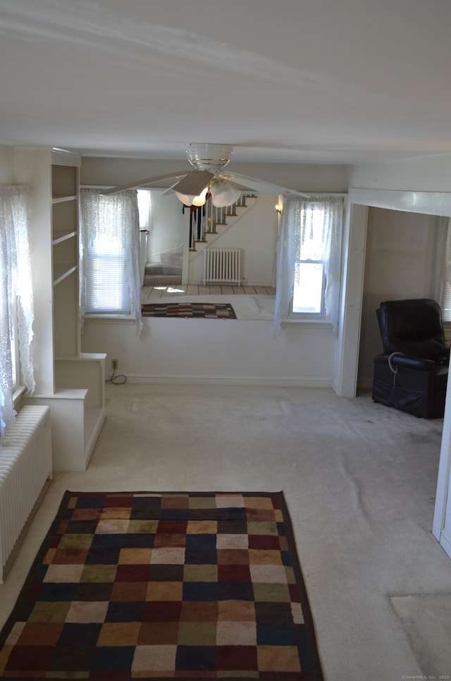 interior space featuring radiator heating unit and carpet floors