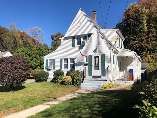 view of front of house featuring cooling unit and a front lawn