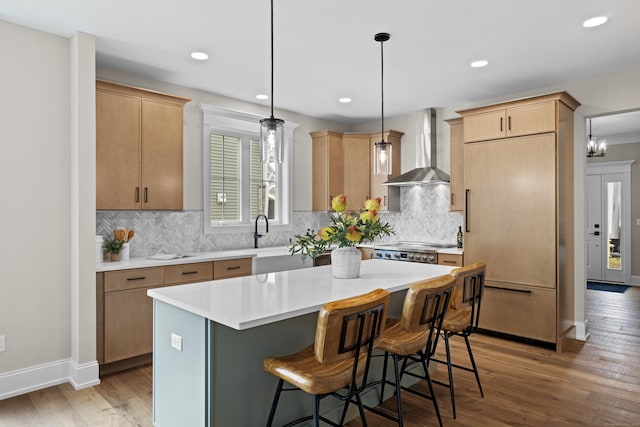 65 Soderman Way Unit 65, Cheshire, CT 06410 - kitchen featuring wall chimney exhaust hood, paneled built in fridge, light wood-type flooring, a breakfast bar area, and a kitchen island