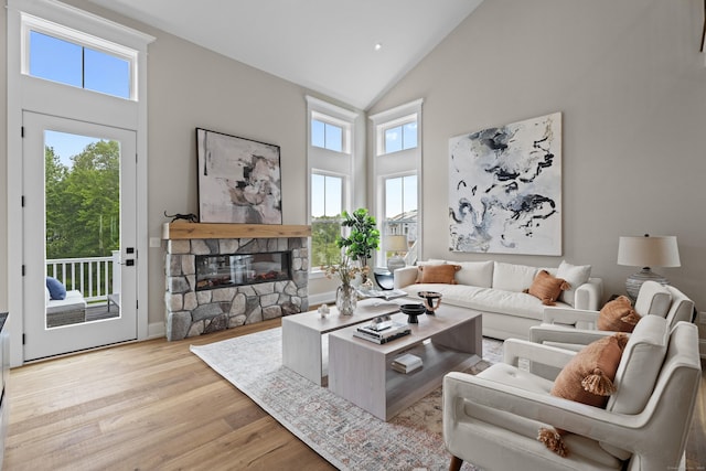 65 Soderman Way Unit 65, Cheshire, CT 06410 - living area featuring high vaulted ceiling, wood finished floors, and a stone fireplace