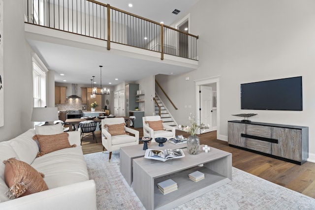 65 Soderman Way Unit 65, Cheshire, CT 06410 - living room featuring stairway, wood finished floors, a high ceiling, recessed lighting, and a chandelier