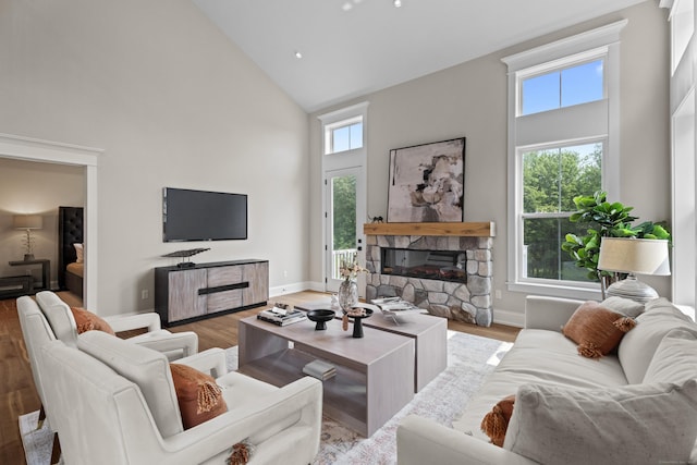 65 Soderman Way Unit 65, Cheshire, CT 06410 - living room with high vaulted ceiling, a fireplace, healthy amount of natural light, and light wood finished floors