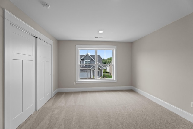 65 Soderman Way Unit 65, Cheshire, CT 06410 - unfurnished bedroom with light carpet, a closet, and recessed lighting
