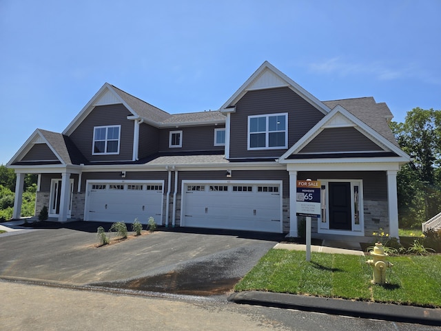 65 Soderman Way Unit 65, Cheshire, CT 06410 - view of property with asphalt driveway, a garage, covered porch, roof with shingles, and stone siding