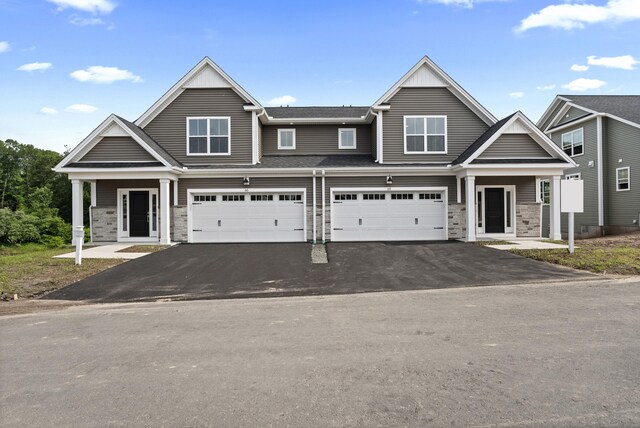 65 Soderman Way Unit 65, Cheshire, CT 06410 - view of front of home featuring asphalt driveway, an attached garage, and stone siding