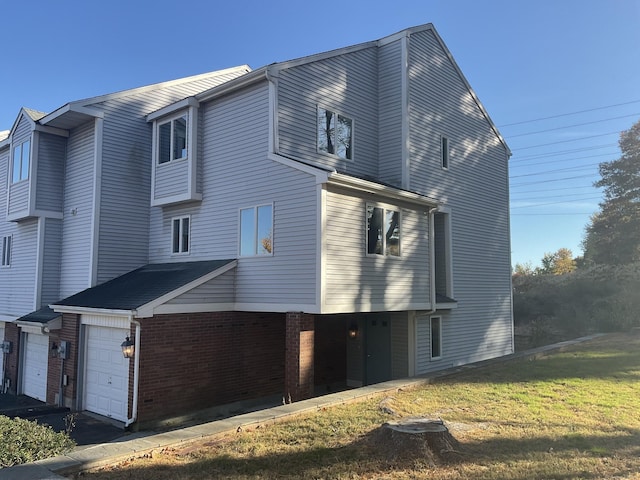 view of home's exterior with a garage and a lawn