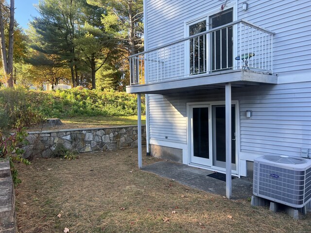 view of yard featuring a balcony and central air condition unit