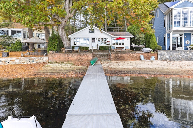 view of dock featuring a gazebo and a water view