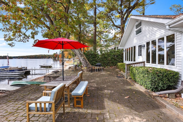 view of patio / terrace featuring a water view and a boat dock