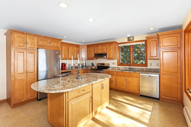 199 Pine Hollow Rd, Killingly, CT 06241 - kitchen with stainless steel appliances, range hood, light stone counters, a baseboard radiator, and a kitchen island