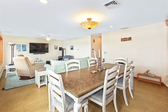 tiled dining space featuring ceiling fan