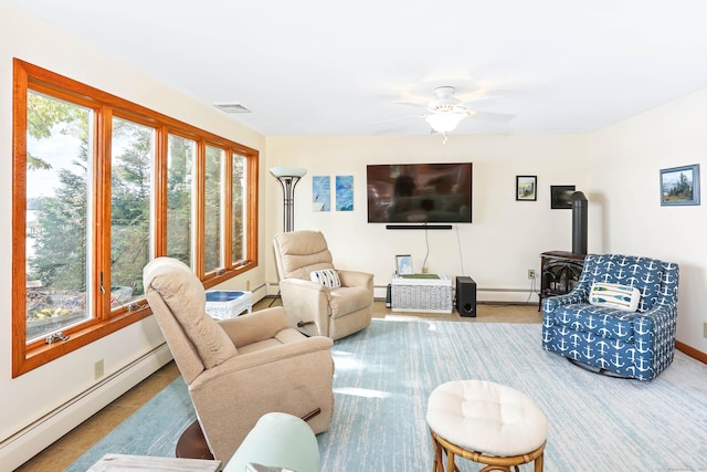 199 Pine Hollow Rd, Killingly, CT 06241 - tiled living area featuring a baseboard radiator, a wood stove, and ceiling fan