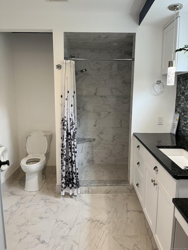 full bathroom with toilet, a tile shower, marble finish floor, and vanity