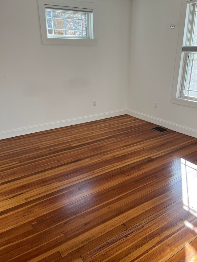 spare room featuring dark hardwood / wood-style floors