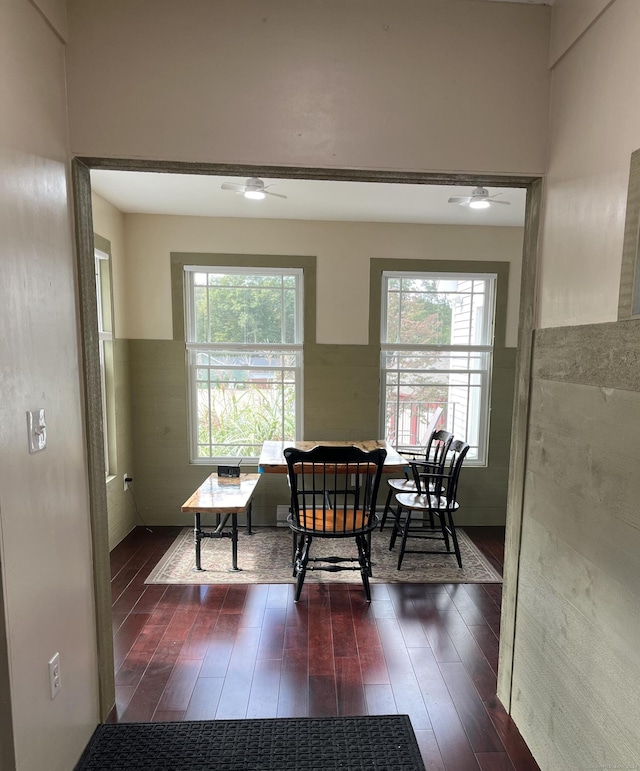 dining area with dark wood-type flooring and ceiling fan