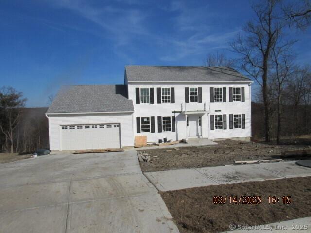 colonial home featuring driveway and an attached garage