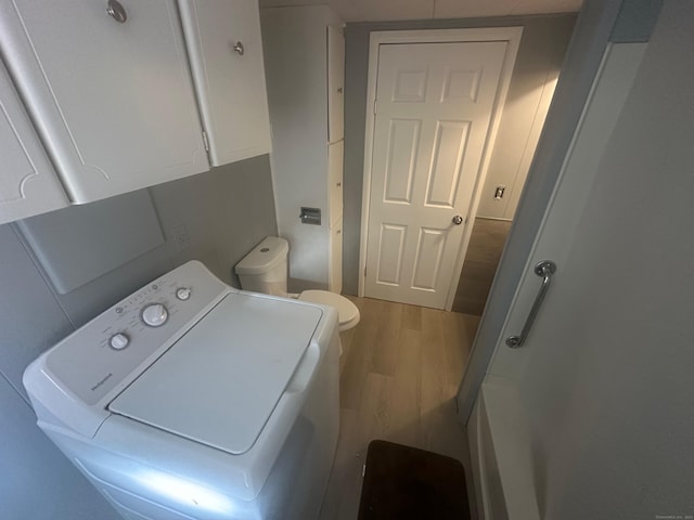 laundry area with washer / dryer and hardwood / wood-style flooring